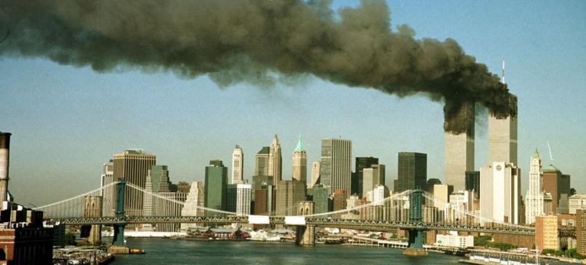 A September 11, 2001 file photo shows the towers of New York's World Trade Center pour smoke shortly after being struck by hijacked commercial aircraft. New York City plans to mark the third anniversary of the attacks on the trade center with an observance at the site on September 11 with parents and grandparents of victims reading their names. REUTERS/Brad Rickerby  JDP